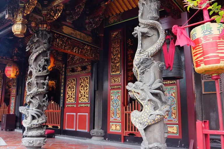 Carved stone dragon columns wound around the pillars of Dalongdong Baoan Temple in Taipei