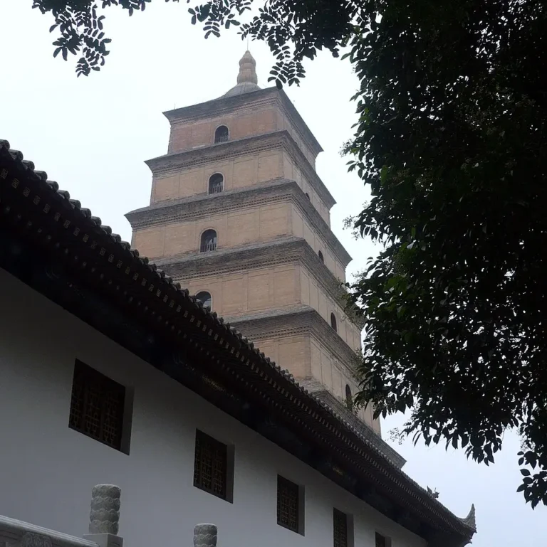 The Big Wild Goose Pagoda in Xi'an, a seven-storey brick pagoda of stepped tiers, seen from the courtyard below against a clear sky.