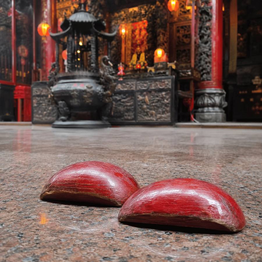jiaobei moon blocks pair resting curved side up on a temple floor in taiwan