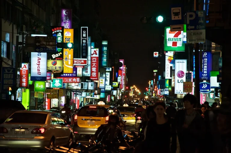 Shop signs along Tingzhou Road in the Gongguan district of Taipei at night, every one of them written in traditional Chinese characters