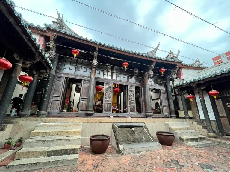 The stone-and-timber front of the Penghu Tianhou Temple in Magong, the oldest Mazu temple in Taiwan, with its swallowtail roof ridges and carved entrance.